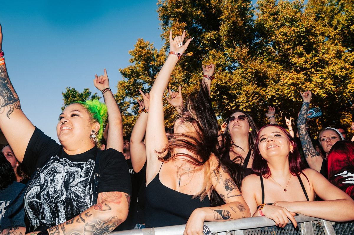 Mosh pit at a heavy metal festival, hands raised